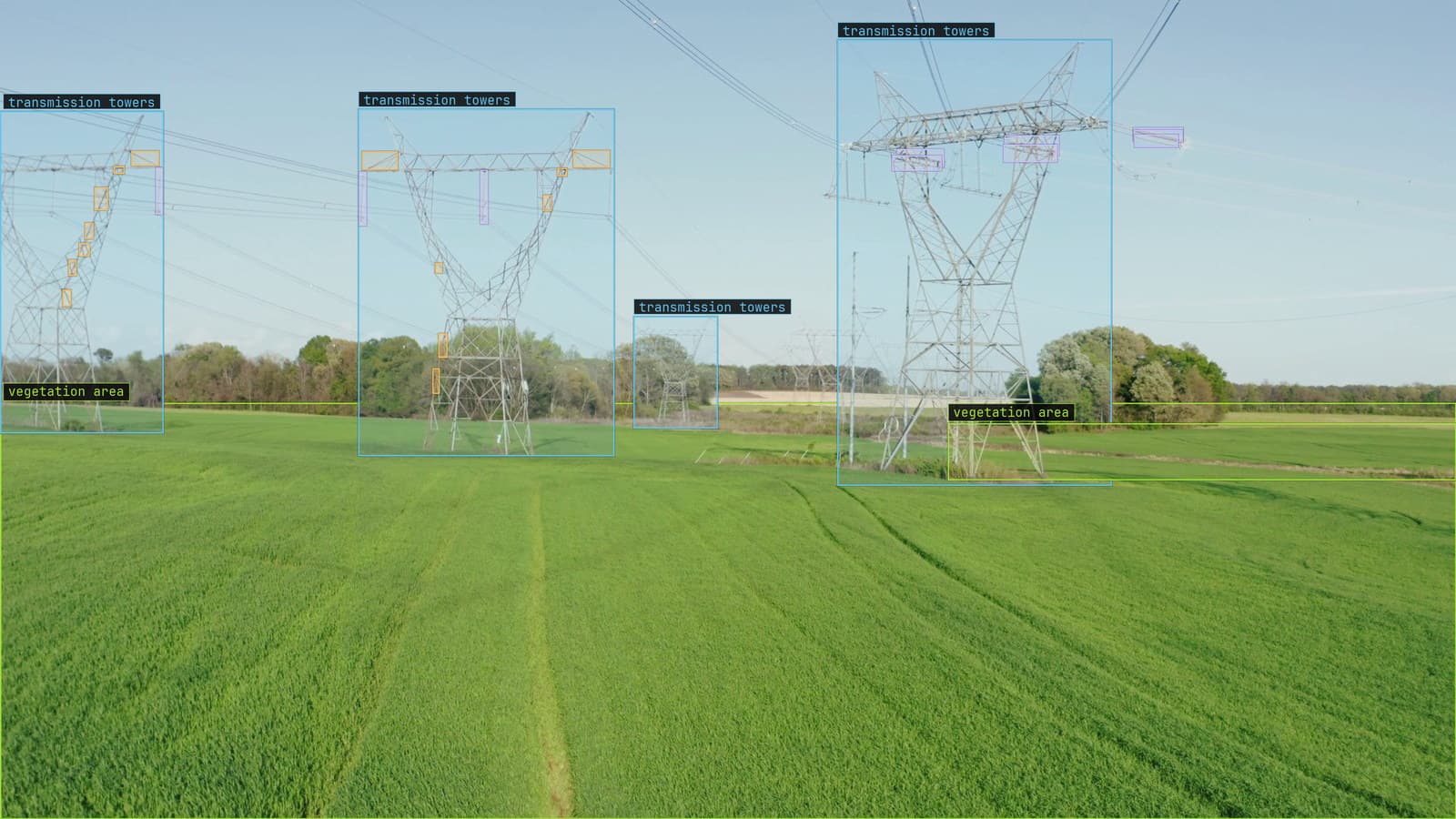 Three transmission towers across a field, insulators boxed, defects flagged and vegetation marked near the line, from a customer aerial survey