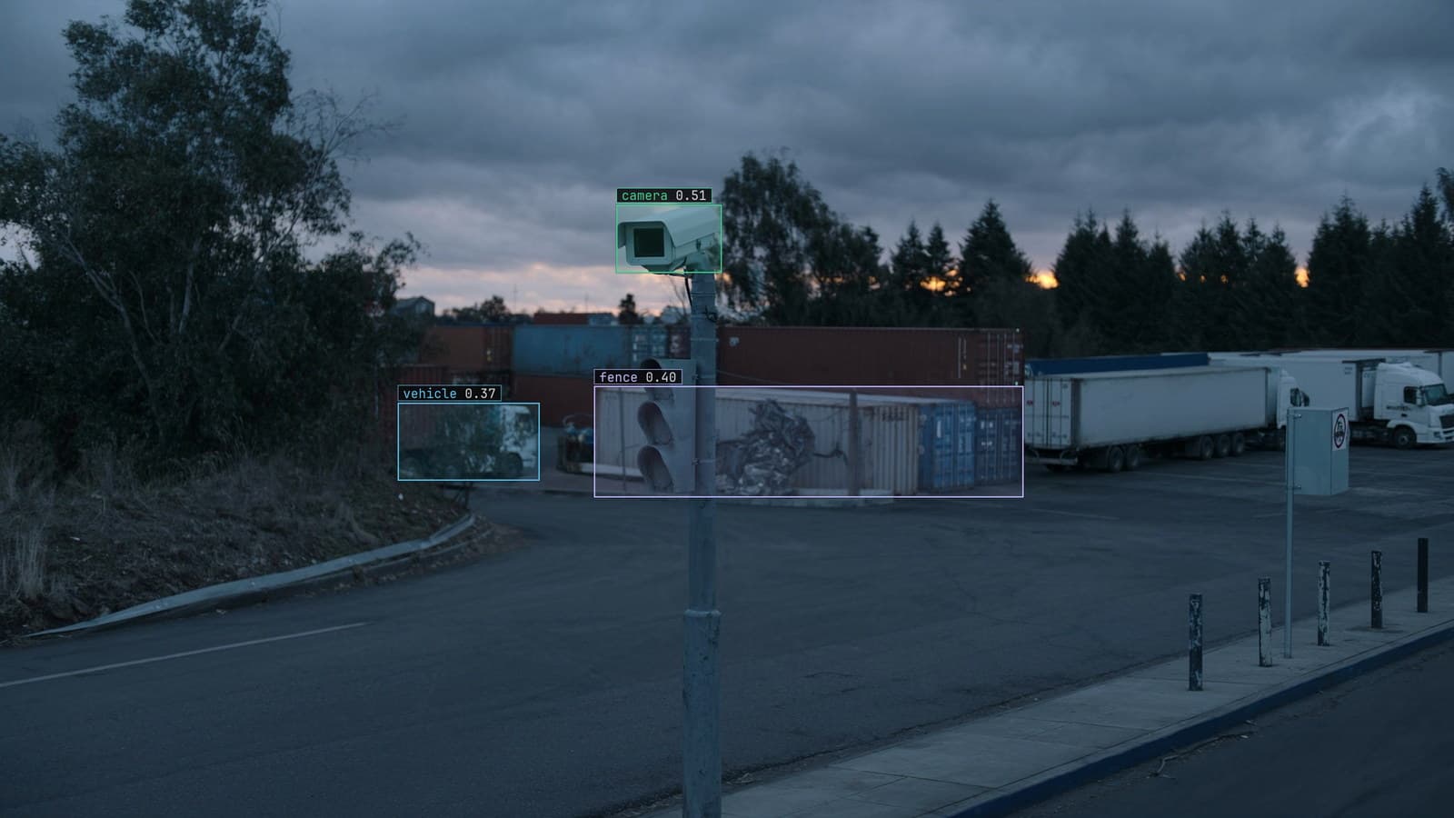 Camera on a pole over an industrial yard at dusk, camera, fence and vehicle boxed, generated scene with detections from our model