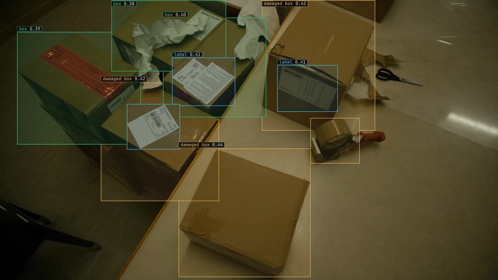 Overhead view of a parcel packing station with boxes, tape and a crushed carton boxed, generated scene with detections from our model