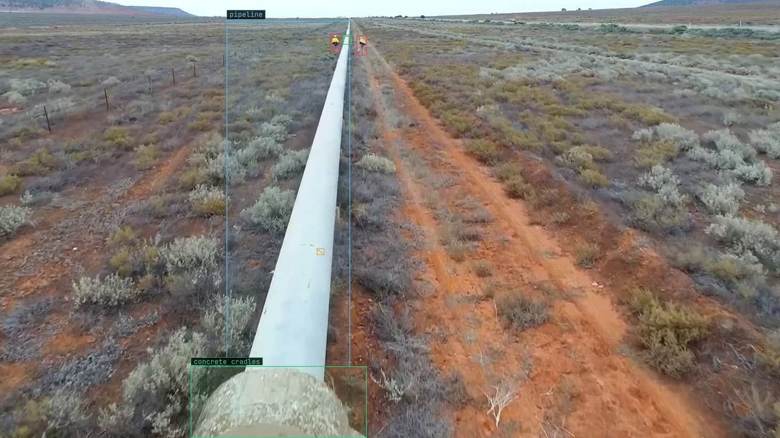 A pipeline over a concrete cradle, rust flagged along the pipe, from a customer drone survey
